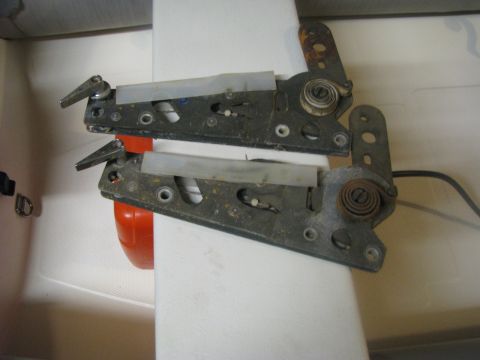 2005 Ford Excursion - Two metal seat adjustment mechanisms with visible springs and levers are shown.