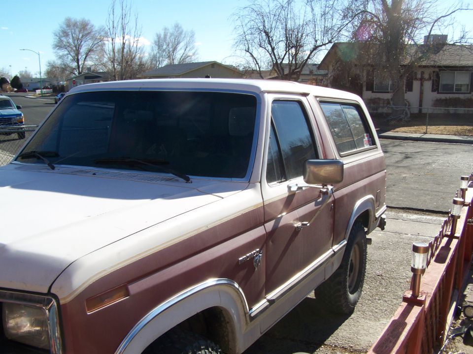 Brown and white Ford Bronco, side view, showing two-tone paint and chrome trim