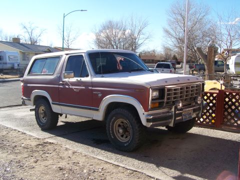 1981 Ford Bronco - This 1981 Ford Bronco features a two-tone red and white paint scheme and a prominent grille.