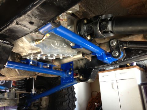 1971 Ford Bronco - Vehicle underbody with an Atlas transfer case and custom blue suspension parts visible.