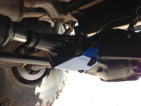 1971 Ford Bronco - Close-up of the undercarriage components, including the drive shaft and suspension system.