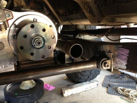 1971 Ford Bronco - Close-up view of a vehicle's undercarriage, focusing on a mechanical component and exhaust pipe. Supermotors.net logo is present.