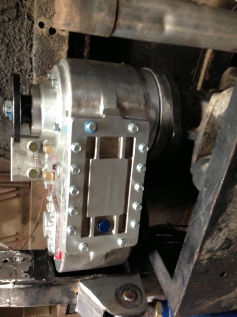 1971 Ford Bronco - Close-up view of an aftermarket transfer case installed on a vehicle's undercarriage.