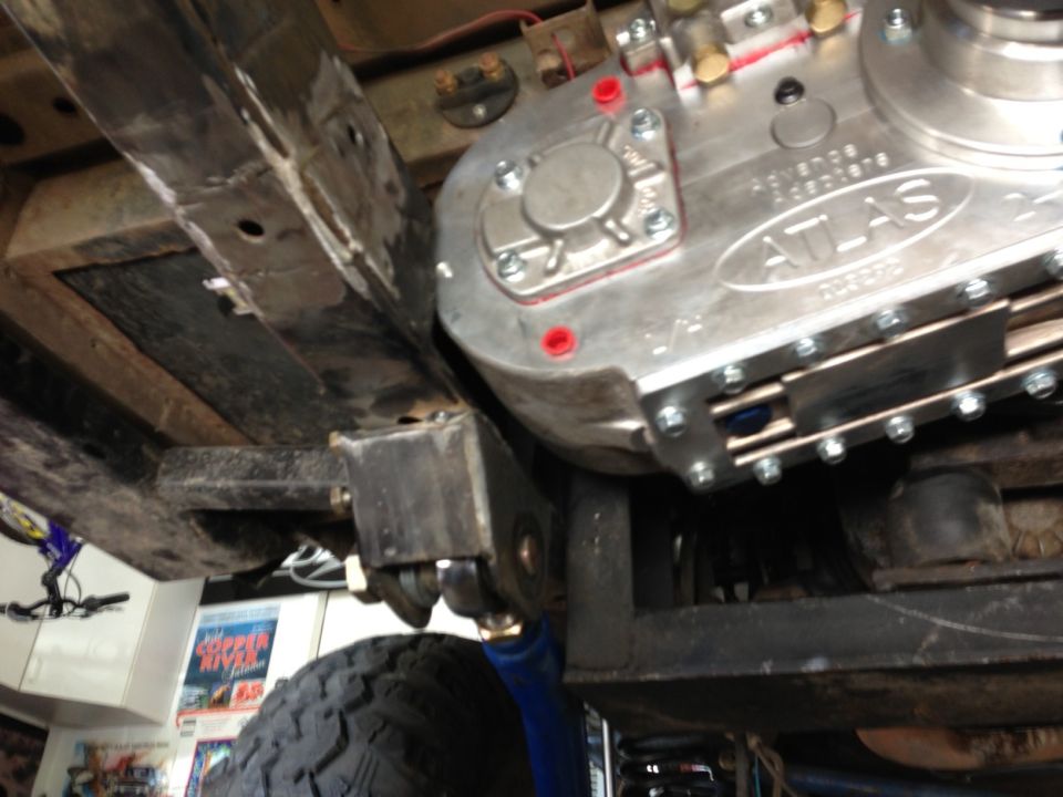 Advance Adapters Atlas transfer case mounted to vehicle frame with suspension components visible