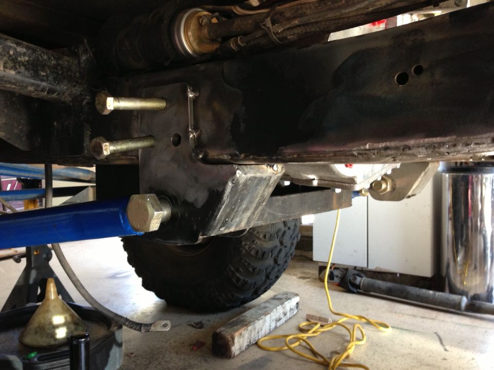 close-up of modified suspension components and frame of a vehicle