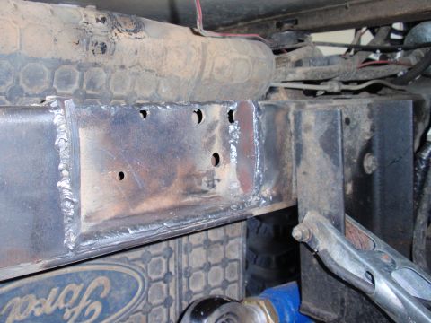 1971 Ford Bronco - Welding work on a vehicle's frame, with a Ford emblem visible in the background.