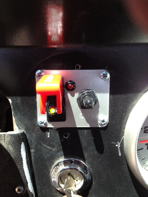 1971 Ford Bronco - Close-up of a vehicle's interior dashboard showing various switches and the ignition.