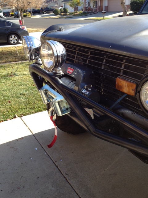 1971 Ford Bronco - The front end of a 1971 Ford Bronco is shown, equipped with a winch and auxiliary lighting.