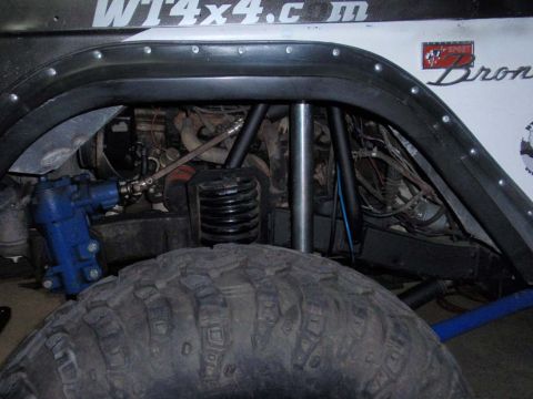 1971 Ford Bronco - Close-up of the front suspension and steering components on a 1971 Ford Bronco, FOA shocks and custom radius arms.