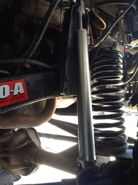 1971 Ford Bronco - Undercarriage view shows a shock absorber and coil spring, with a sticker indicating FO-A Shock Technology.