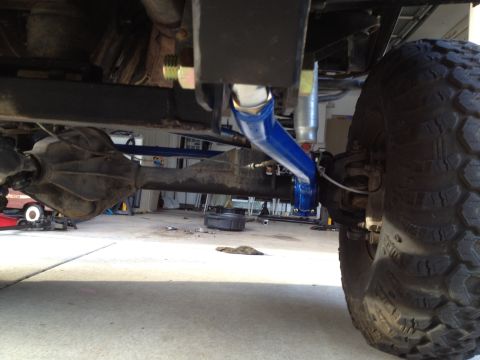 1971 Ford Bronco - Close-up view of the rear axle and suspension system of a vehicle, highlighting custom suspension components.