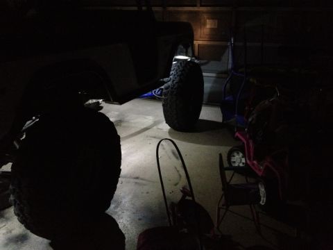 1971 Ford Bronco - Rock lights illuminate the fender and tire of a 1971 Ford Bronco.