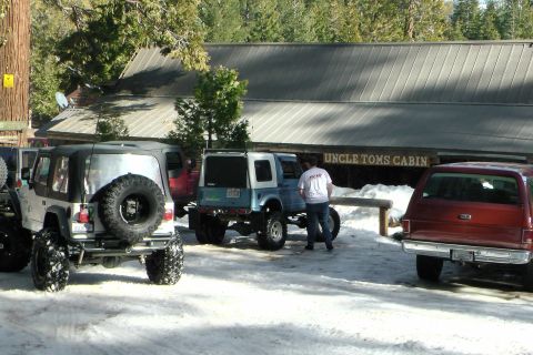 1971 Ford Bronco - Several off-road vehicles are parked in the snow outside Uncle Tom's Cabin.
