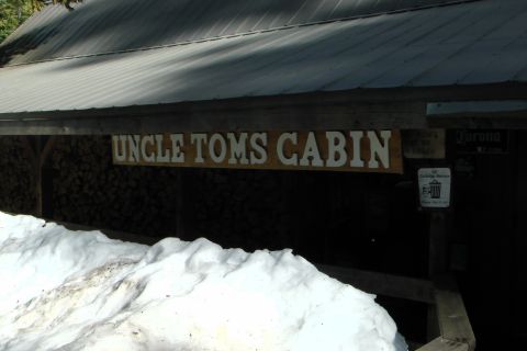 1971 Ford Bronco - Sign for Uncle Tom's Cabin reads 'UNCLE TOMS CABIN' above a pile of snow.