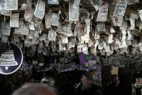1971 Ford Bronco - A bar's ceiling is decorated with numerous dollar bills, creating a unique atmosphere.