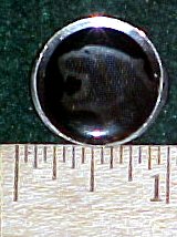 2003 Ford Expedition - A black wheel center cap is shown with a ruler for scale and a SuperMotors.net logo at the bottom.