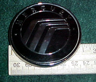 2003 Ford Expedition - A close-up of a Mercury wheel center cap is shown next to a ruler.