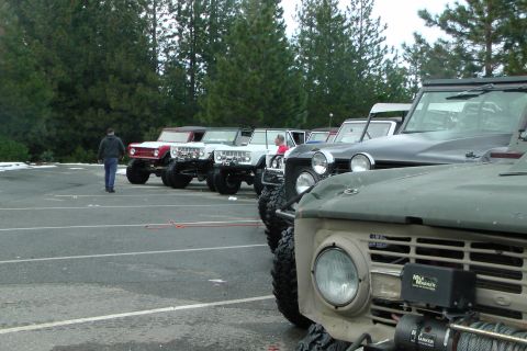1971 Ford Bronco - Several modified Ford Broncos are parked in a lot, ready for off-road adventure.