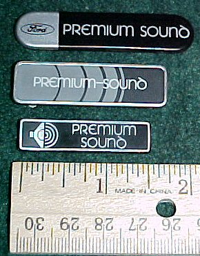 2003 Ford Expedition - Various Ford Premium Sound badges are shown with a ruler for size comparison.