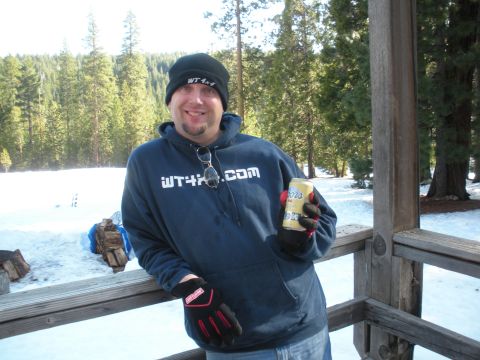 1971 Ford Bronco - A man enjoys a beverage in a snowy, wooded area, with a "WT4x4.com" logo visible on his hoodie.
