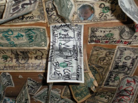 1971 Ford Bronco - Several US dollar bills are covered in handwritten text and one has a photo of a baby.