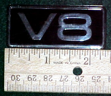 2003 Ford Expedition - A V8 emblem is shown next to a ruler, indicating its size.