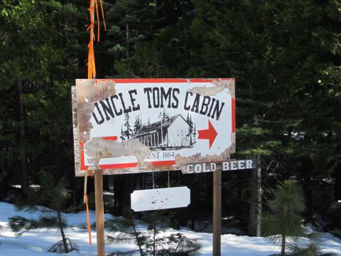 1971 Ford Bronco - A rustic sign points the way to Uncle Tom's Cabin, indicating cold beer is available.