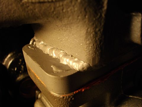 1989 Ford Probe - A close-up view shows a freshly welded seam on a dark metal component, likely part of an engine or exhaust system.