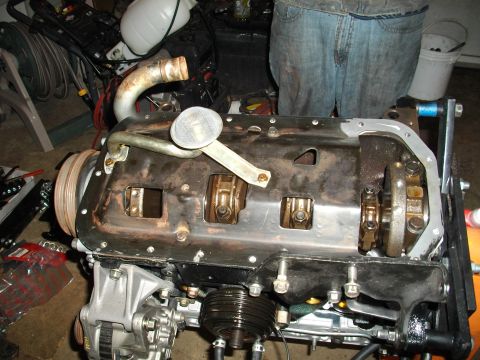 1989 Ford Probe - Engine block with oil pan removed, revealing internal components like the crankshaft and connecting rods.
