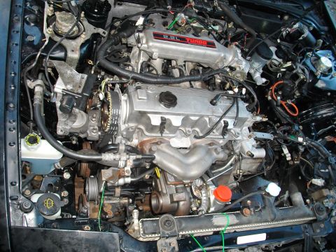 1989 Ford Probe - Close-up view of a vehicle's engine bay, showing the 2.2L turbo engine and surrounding components.