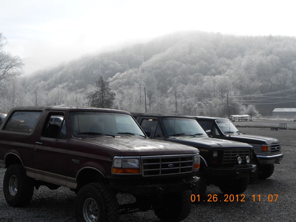 Maroon 1987 Ford Bronco in foreground, two others behind it