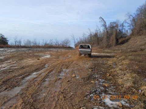 1986 Ford Bronco - 1986 Ford Bronco navigating a challenging muddy off-road course.