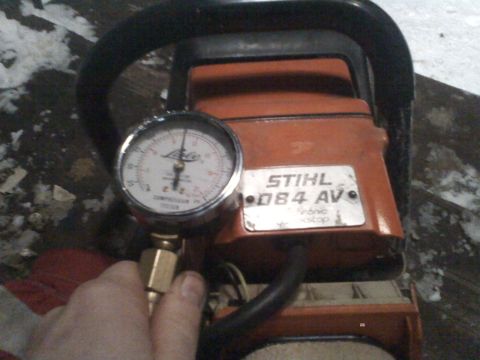 2000 Chevrolet Tahoe - A Stihl D84 AV chainsaw is shown with a compression tester attached to its engine.