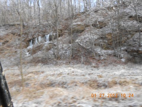 1986 Ford Bronco - A winter scene shows a hillside covered in frost and ice, with icicles forming on the rocks.