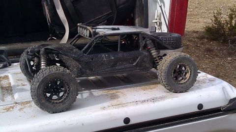 1996 Ford Bronco - A dirty remote control buggy sits on the tailgate of a truck, ready for off-road action.