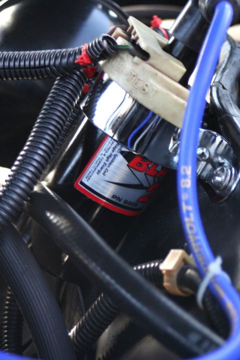 1976 Ford Ranchero - A close-up view of an automotive ignition coil, showing wiring and part identification.