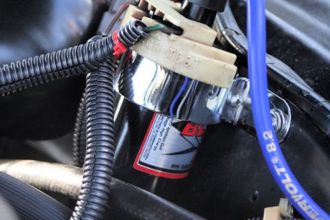 1976 Ford Ranchero - Close-up of an automotive ignition coil and associated wiring, showing a part number and its connections.