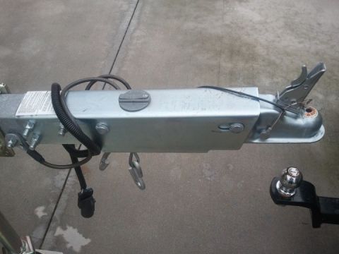 1994 Ford Bronco - Close-up of a trailer's coupler and hitch mechanism, with a ball mount visible.