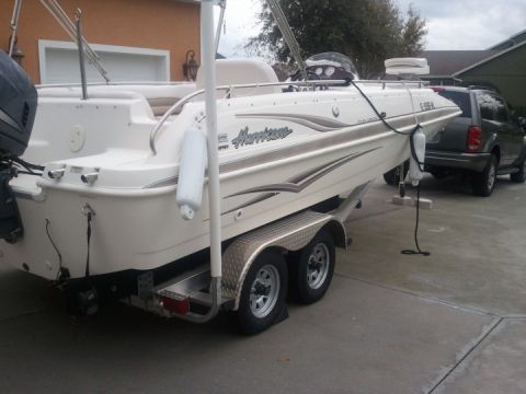 1994 Ford Bronco - Boat on trailer with SUV in background.