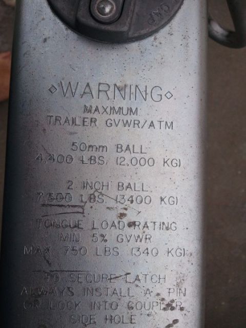 1994 Ford Bronco - Cast warning/rating plate on a trailer hitch listing maximum trailer GVWR/ATM and tongue load specifications.