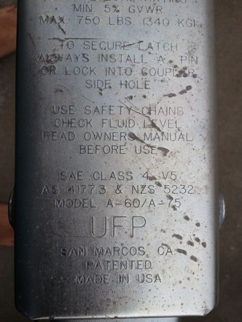 1994 Ford Bronco - This trailer hitch data plate shows UFP branding and load specifications, including a maximum capacity of 750 lbs.