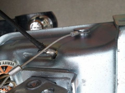 1994 Ford Bronco - Detail of a metal component with a cable and a warning sticker visible.
