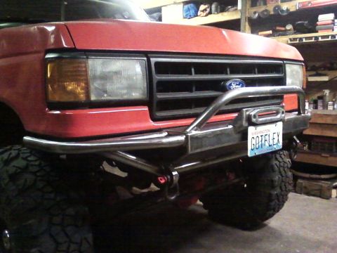 1989 Ford Bronco - Custom bumper and winch installed on a red Ford truck, likely from the late 1980s.