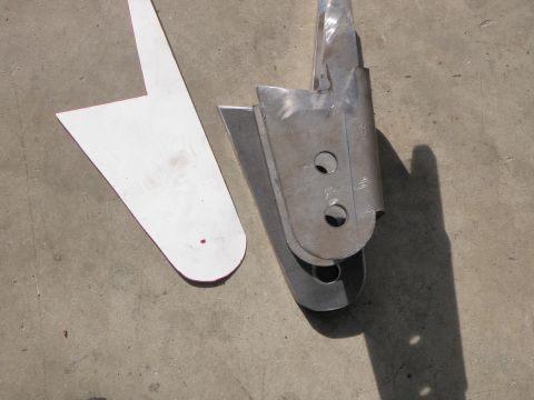 1961 International Scout 800 - Two metal suspension components and a white template lie on a concrete surface.