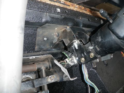 1961 International Scout 800 - The photo shows the steering column and associated wiring and mounting brackets inside a vehicle's dashboard area.