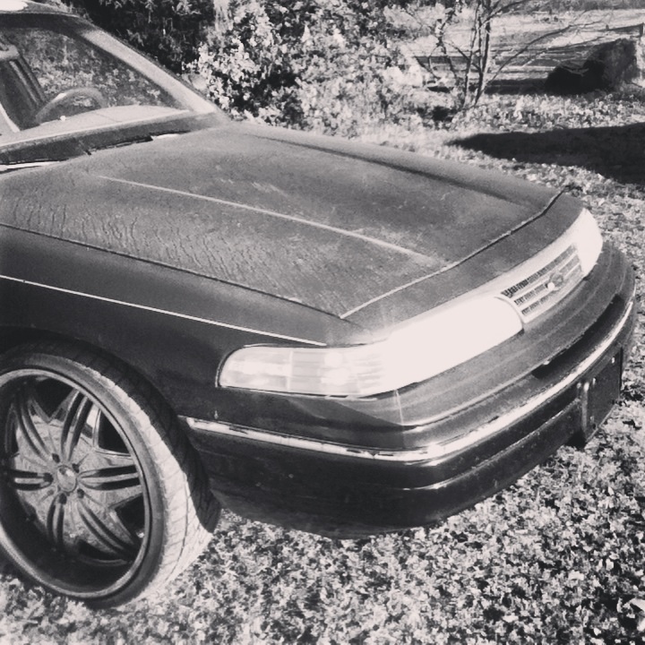 Black Ford Crown Victoria front end with chrome grille and aftermarket rims