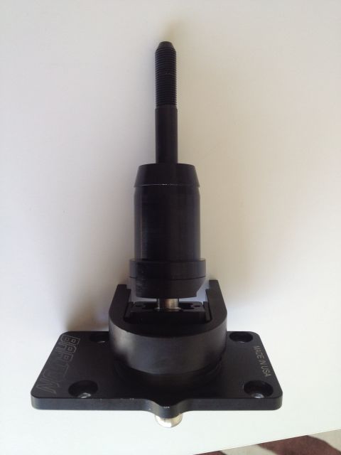 2013 Ford Mustang - This black shift knob assembly features a threaded top and a base plate with "MADE IN USA" visible.