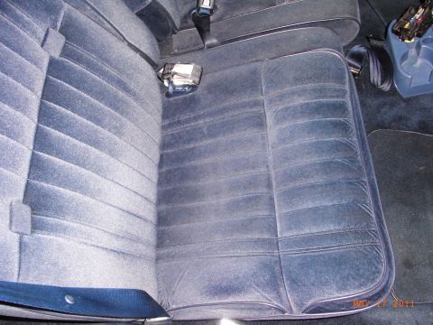 1991 Ford Crown Victoria LTD - The interior of a car shows blue velour seats and a seatbelt buckle, with a date stamp of May 27, 2011.
