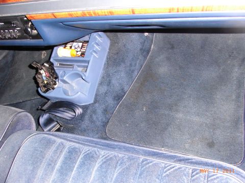 1991 Ford Crown Victoria LTD - The interior of a 1991 Ford Crown Victoria LTD features a blue velour seat and a center console with cup holders.