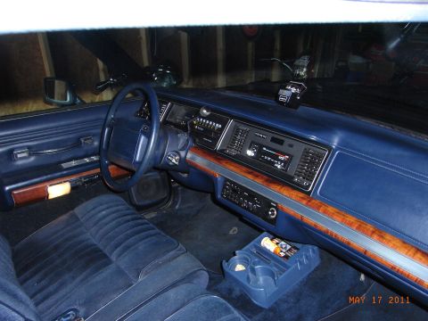 1991 Ford Crown Victoria LTD - Interior view of a 1991 Ford Crown Victoria LTD, blue velour upholstery and wood trim accents.